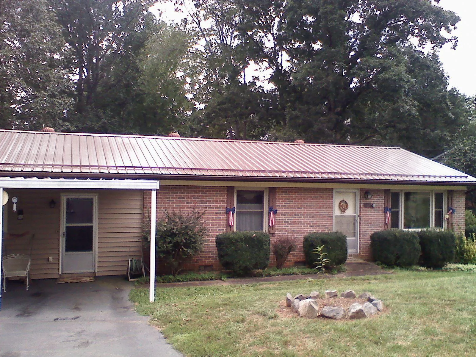 Bronze metal roof and carport on a brick ranch home — Roof Repair work by our crew in Guinda