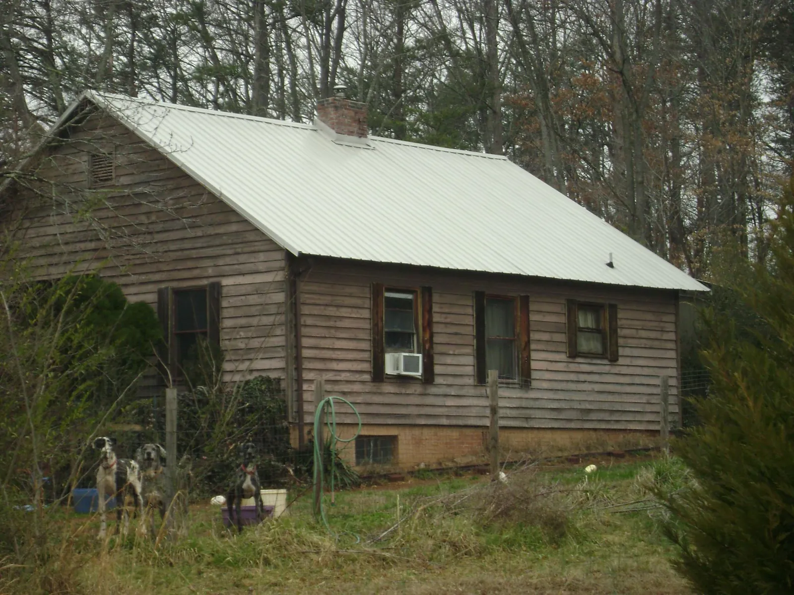 White metal roof on an old wood sided farmhouse, from a Metal Roof Installation job in Guinda